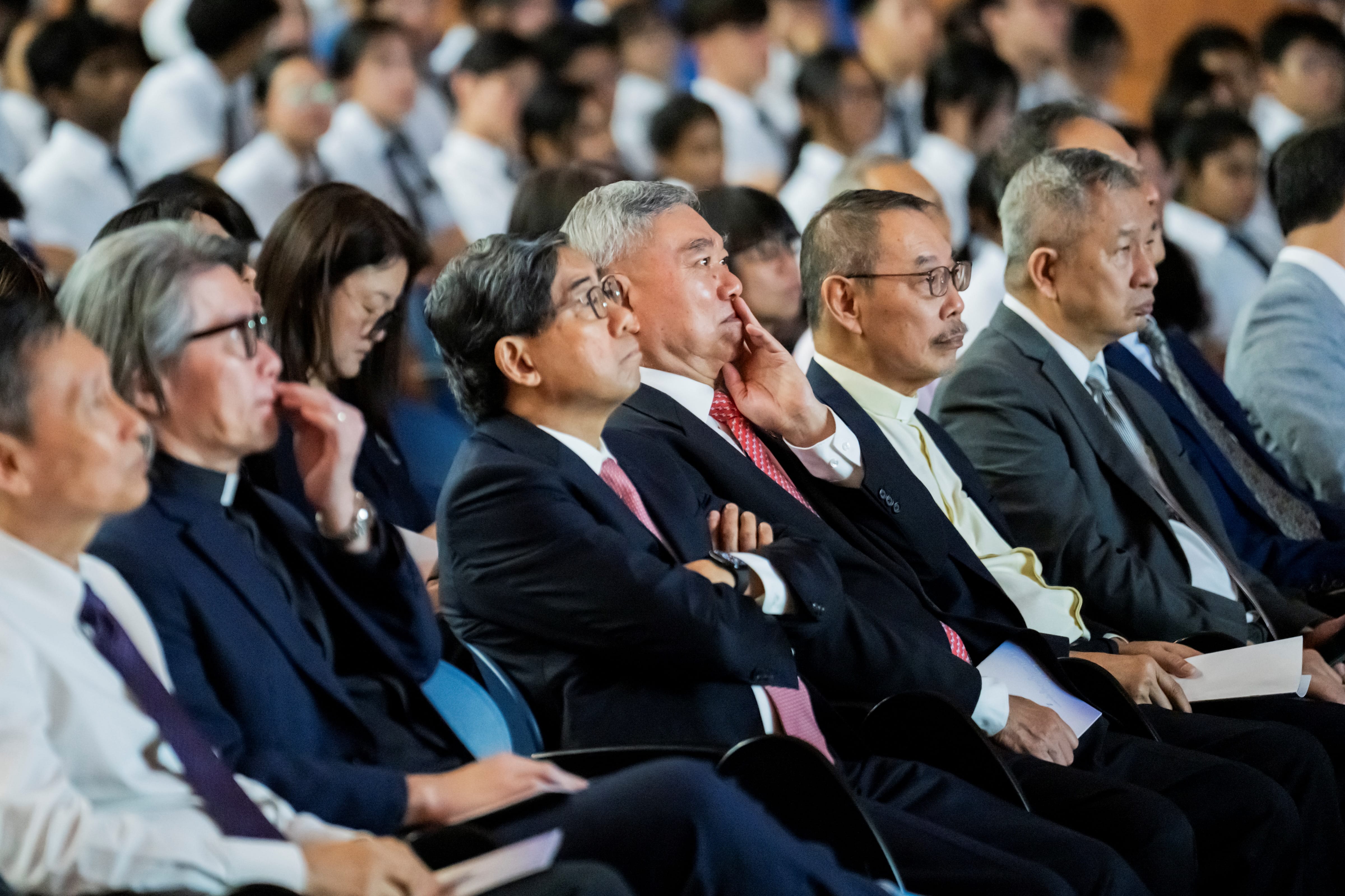 Our guests, comprising our Vice Principal, Mr Ang, Reverend David from the Church of the Resurrection, guest of Honour Dr Yeo, Chairman of the St Andrew's Board of Governors Mr Tan, and other guests seated in the front row of the auditorium looking at the stage.